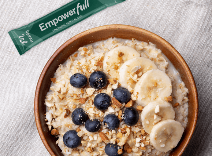 Empowerfull packet next to oatmeal with blueberries and bananas