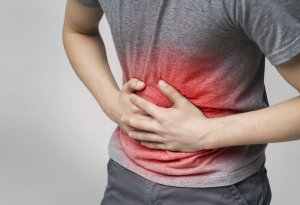 A man holding his stomach with red accents