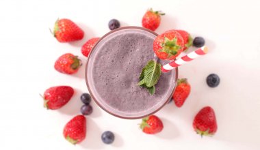 A colorful shake with blueberries and strawberries