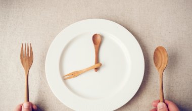 An image of wood cutlery on an empty plate