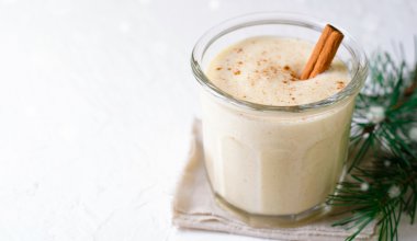 An image of a holiday eggnog drink in a glass