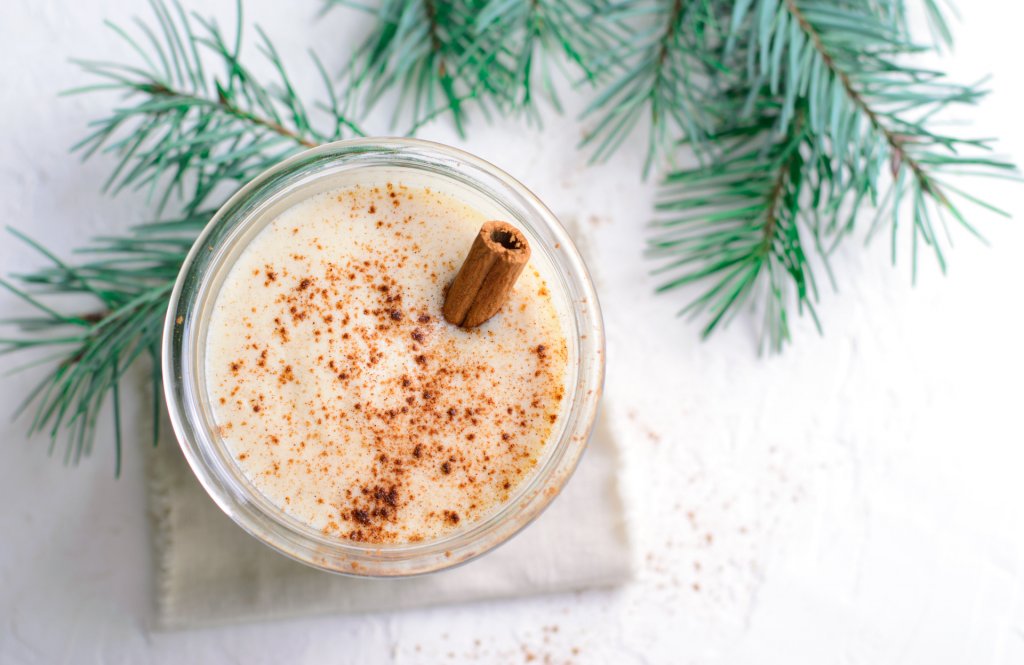 An image of a holiday eggnog drink in a glass